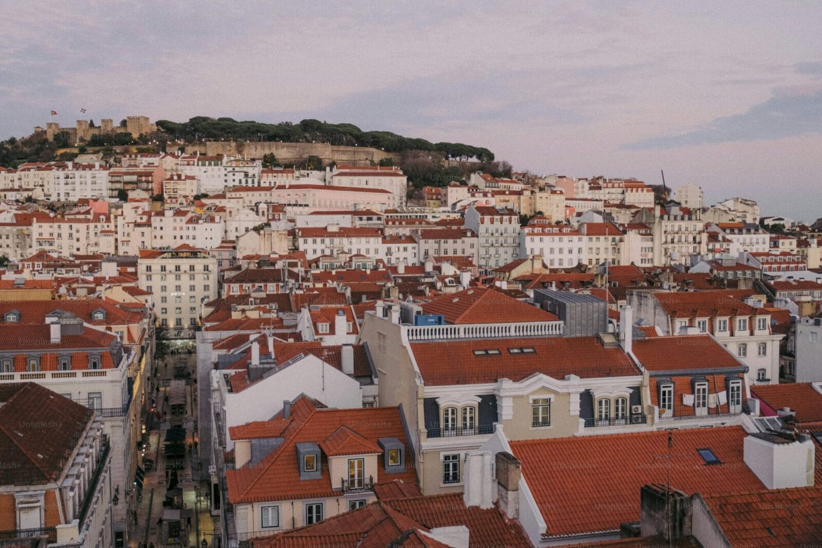 Alfama rooftops at golden hour with Castelo São Jorge, Lisbon, Portugal