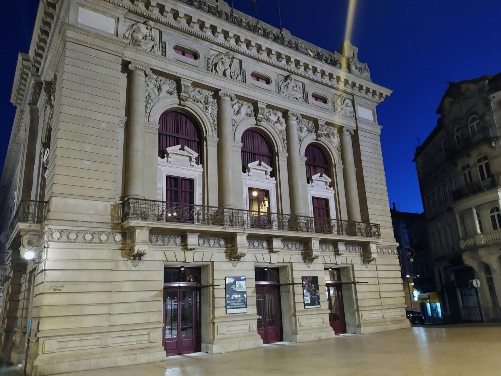 Illuminated facade of Teatro Nacional São João in Porto