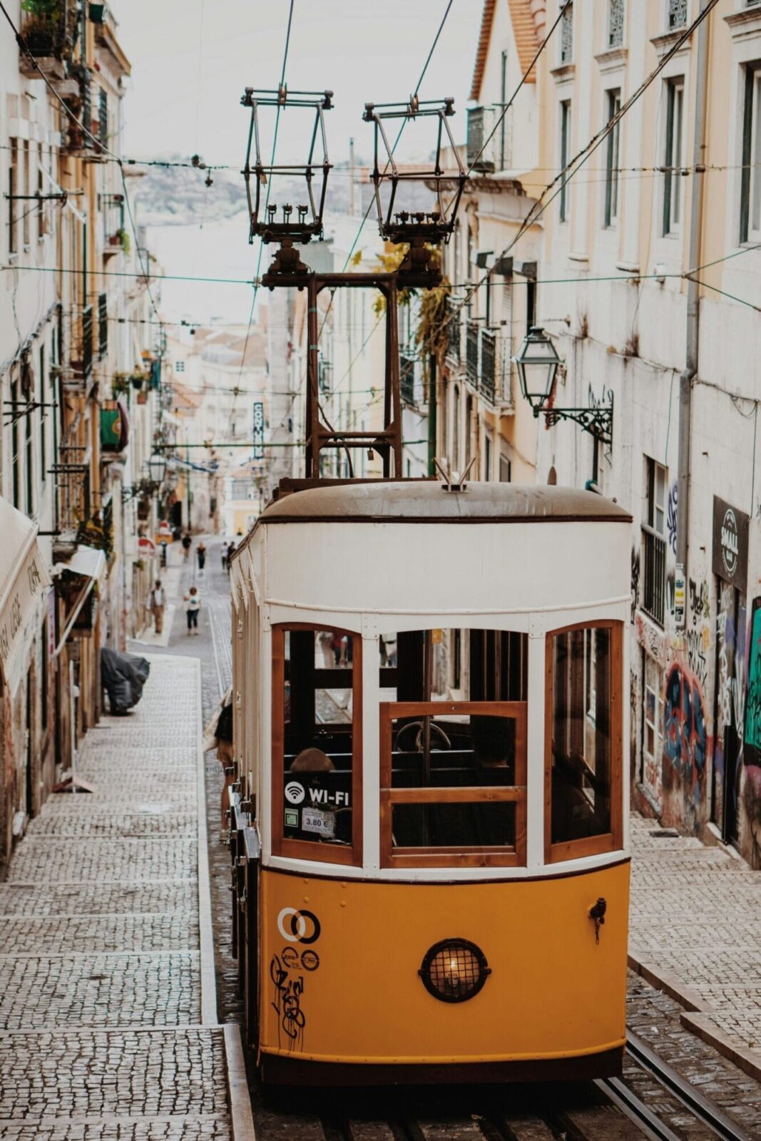 Historic Glória tram climbing a Lisbon hill