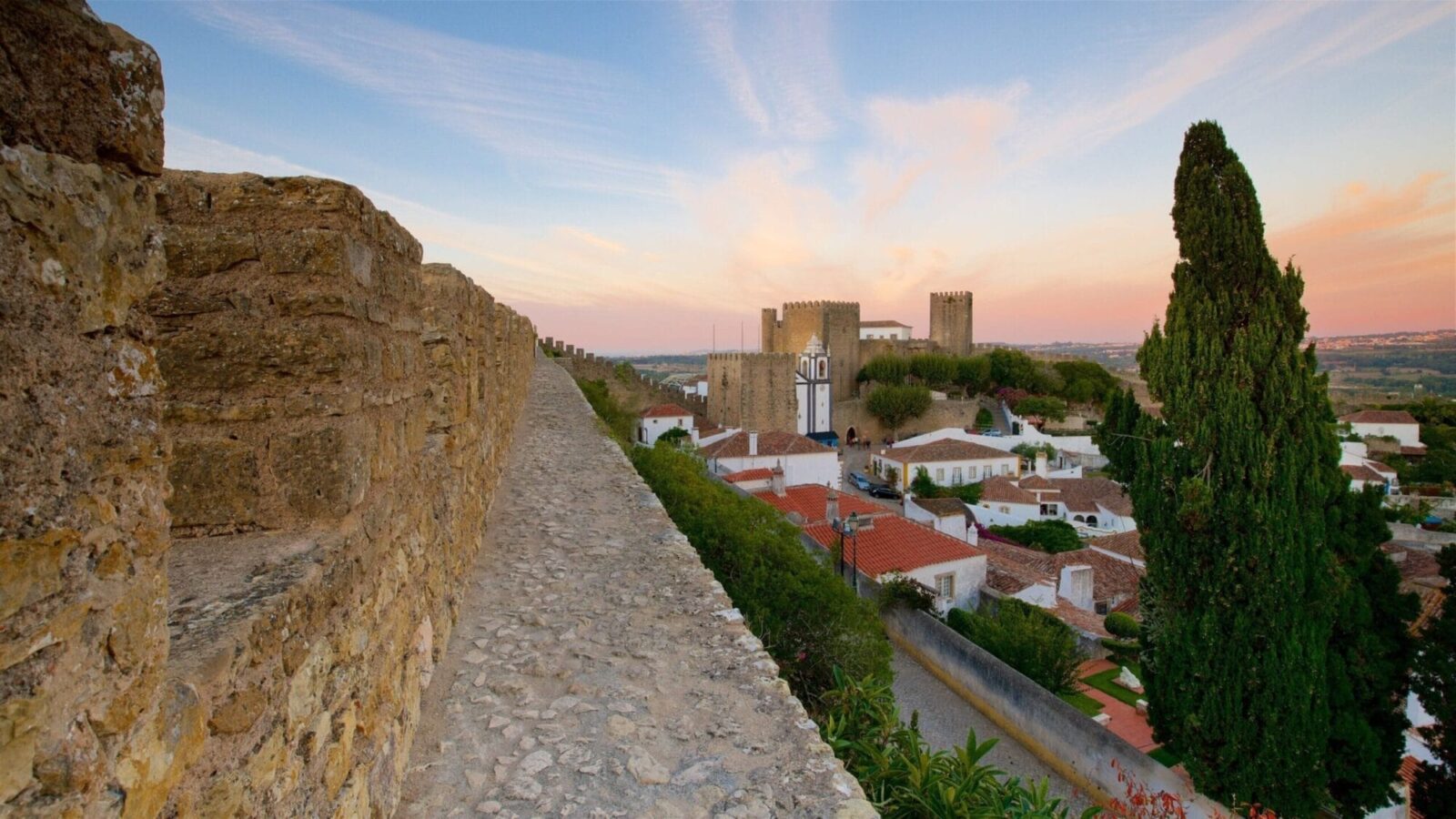 Óbidos medieval castle walls at sunset, Portugal