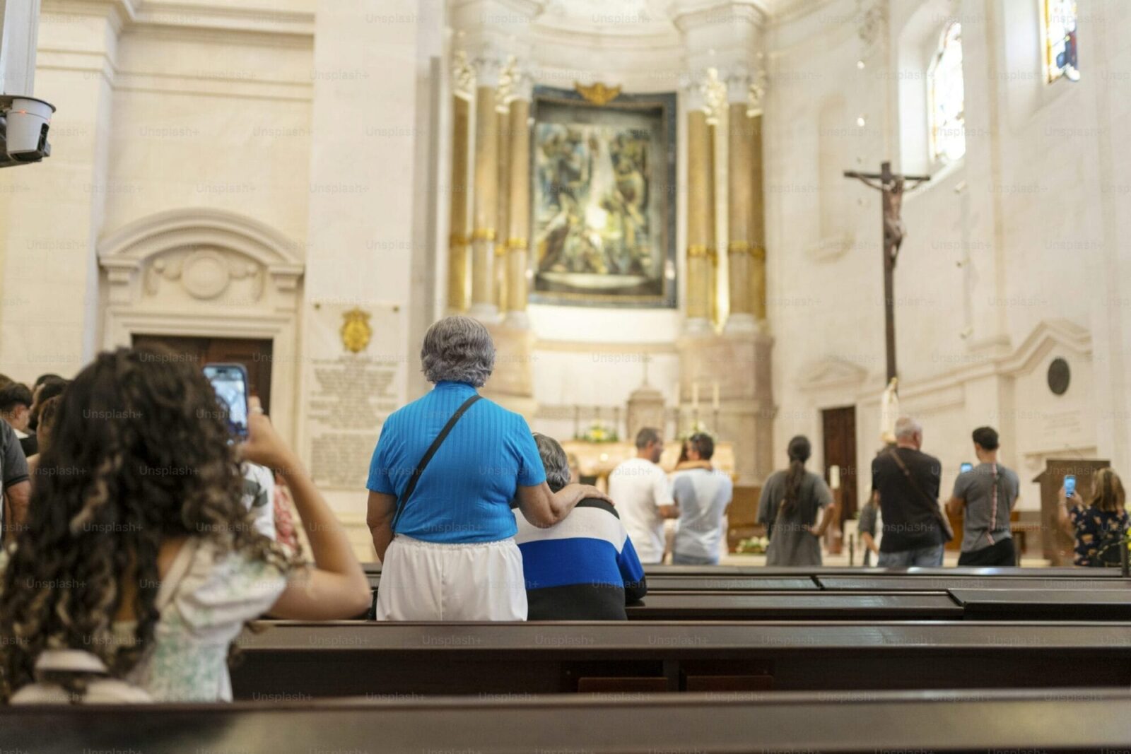 Interior of the Fátima Sanctuary with candlelight and pilgrims